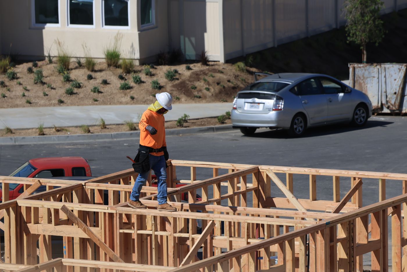 Builder at a house construction site — illustrative stock photograph