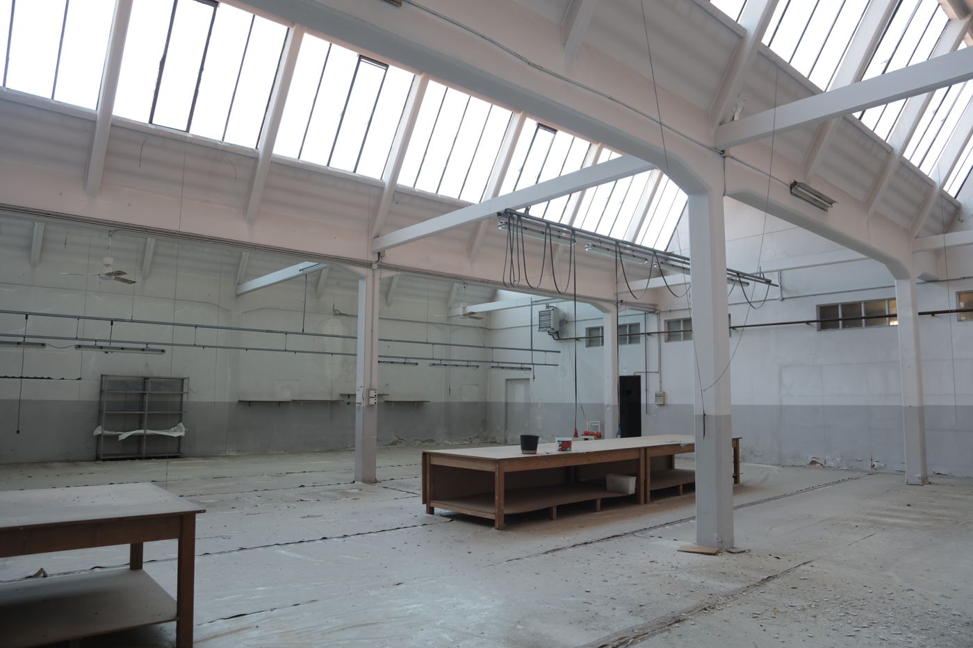 Bright warehouse interior with skylights and steel structure — illustrative stock photograph