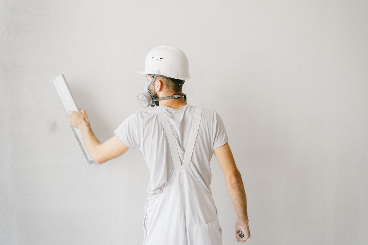 Contractor working on a house wall — illustrative stock photograph