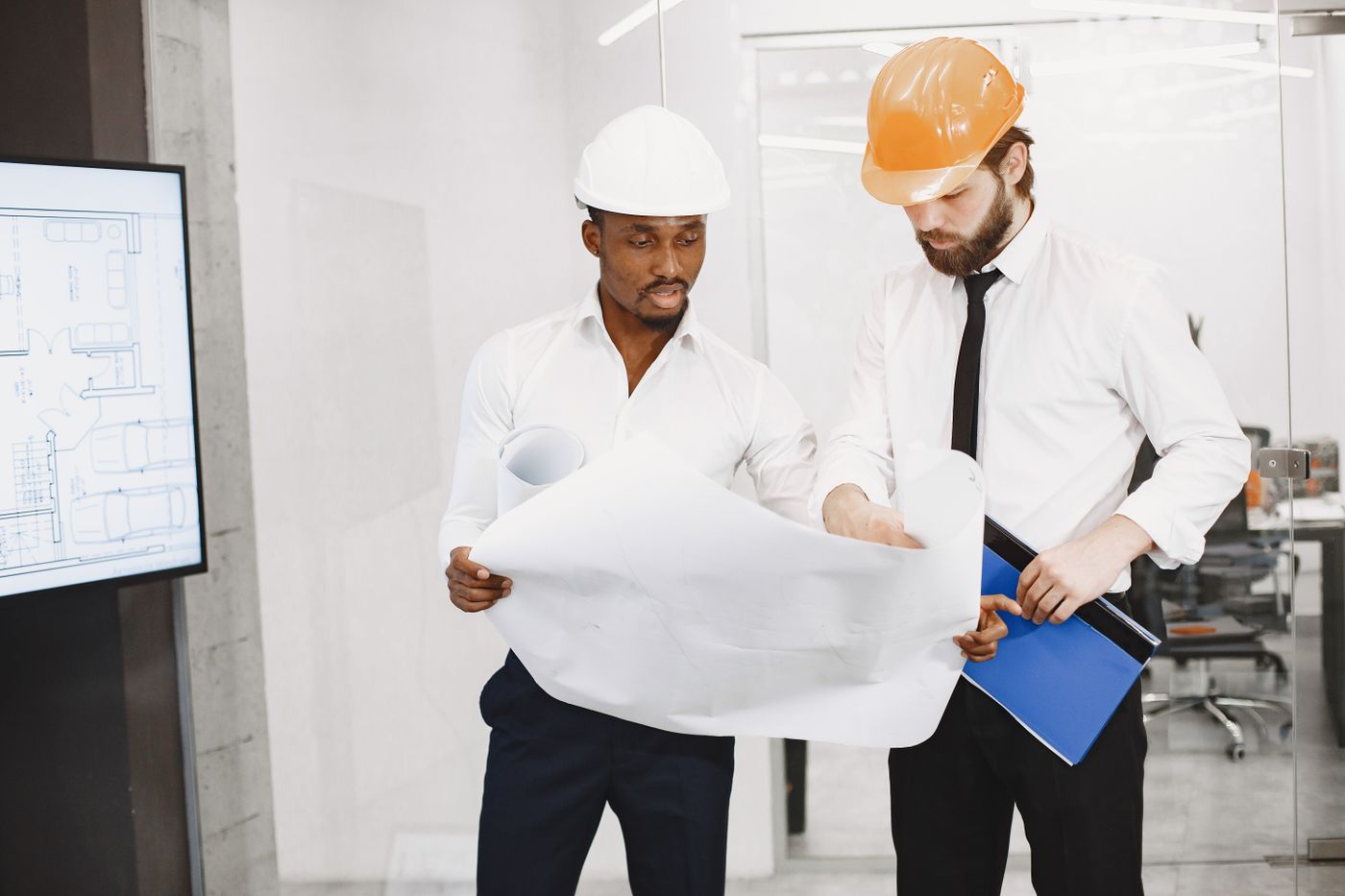 Project team reviewing a blueprint — illustrative stock photograph